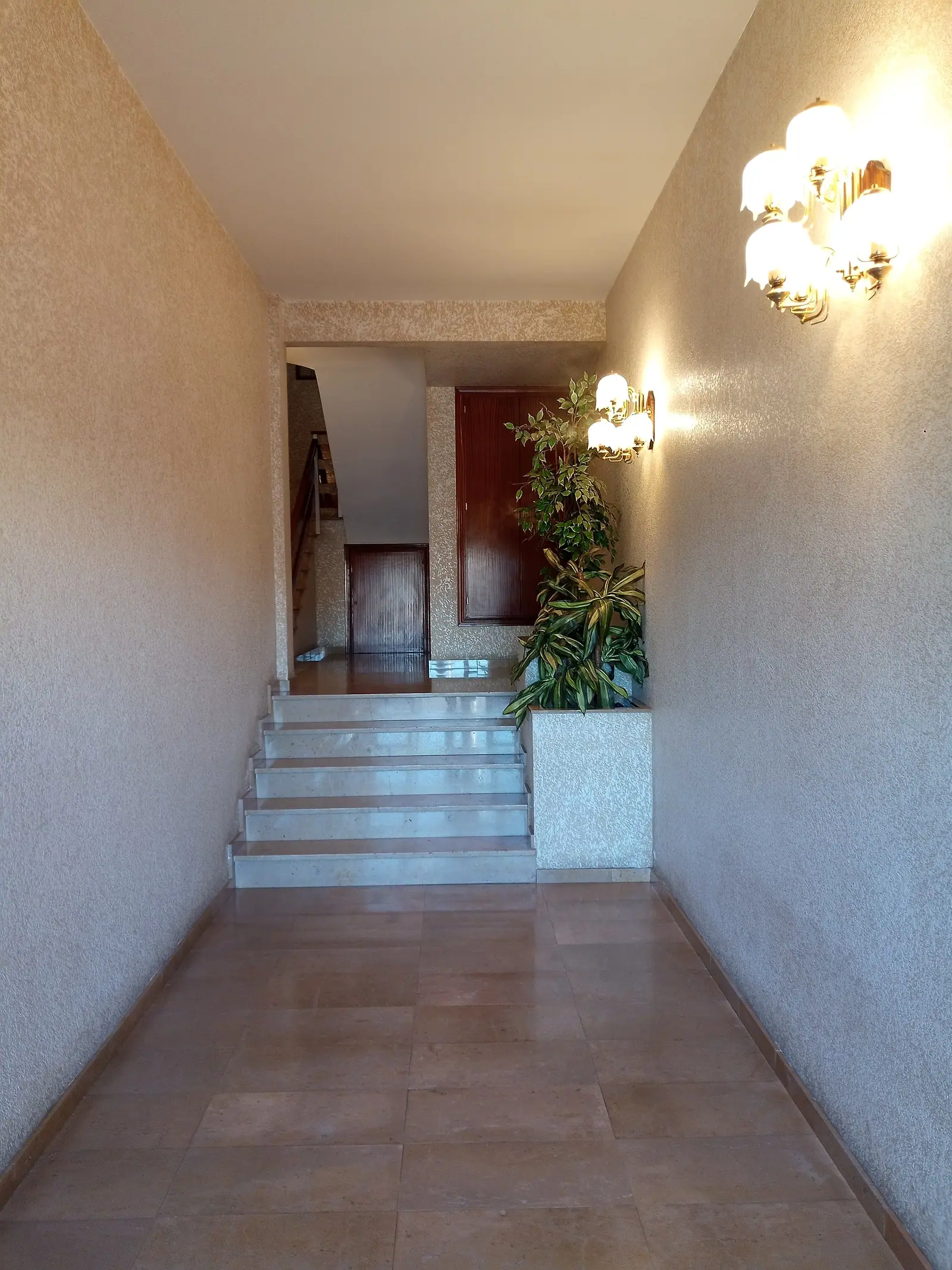 Entrance hall and stairway up to the apartment